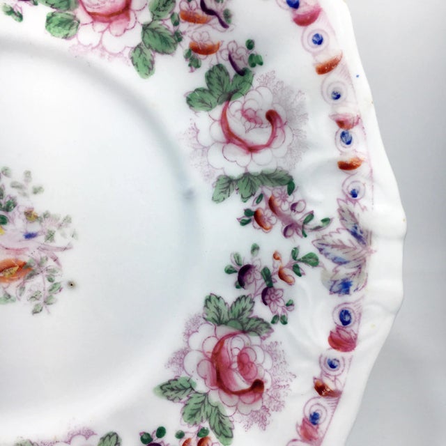 Charming floral rimmed painted plate with bird of paradise at the center. Very faint mark at the back. Dimensions: 10" x...