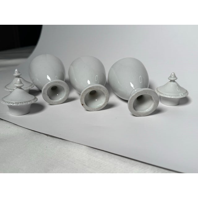 Neoclassical Small White Porcelain Lidded Urns, Set of 3 For Sale - Image 9 of 12