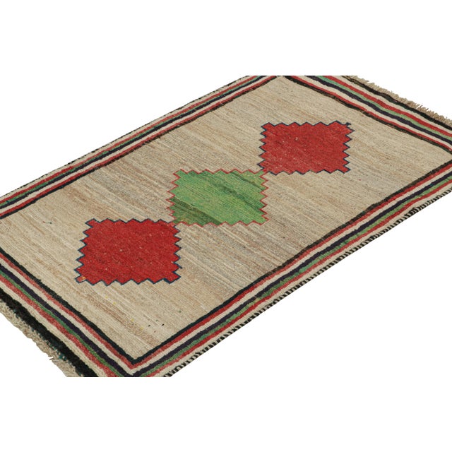 This vintage 3x6 Persian runner is a mid-century tribal piece, hand-knotted in wool circa 1950-1960. Its design is a...