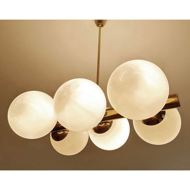 Large vintage stilnovo style pendant light, very rare design featuring a brass beam with 6 opaline glass globe shades Very...