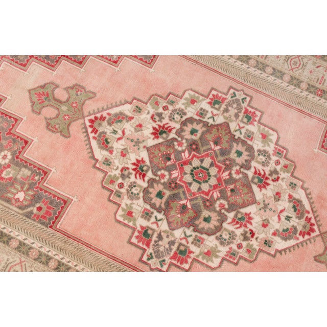 Add an elegant focal point to your room with this beautiful vintage Turkish rug. This hand-knotted piece showcases a...