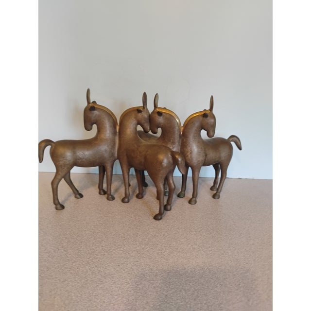 Loet Vanderveen bronze figural wildlife sculpture. Horses Four features a patinated bronze finish with brass trim at the...