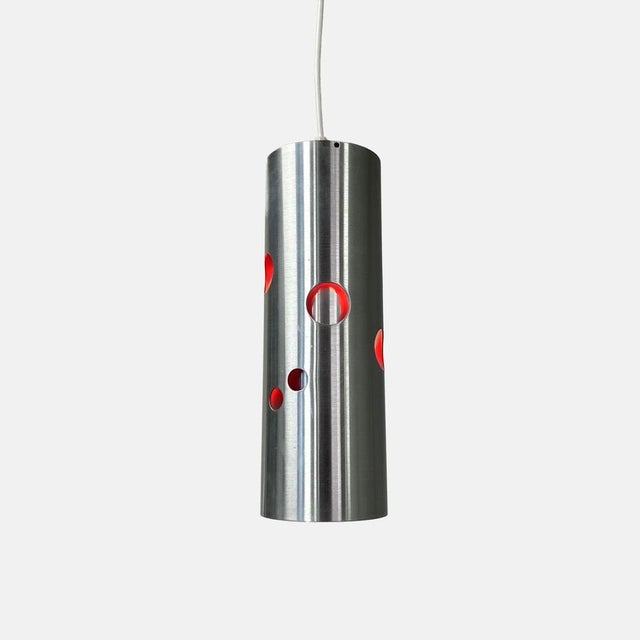 Vintage doria cylinder pendant lamp in aluminium with perforations and a red interior. A bold space age design from the...