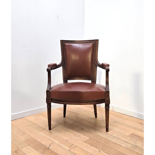 Set of four Empire-style armchairs. Varnished wood frame with brown leather seat and back. with topstitching. In good...