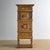 A small cabinet, made in Germany. This piece has a rustic character and is made of pine with an oak base. The cabinet was...