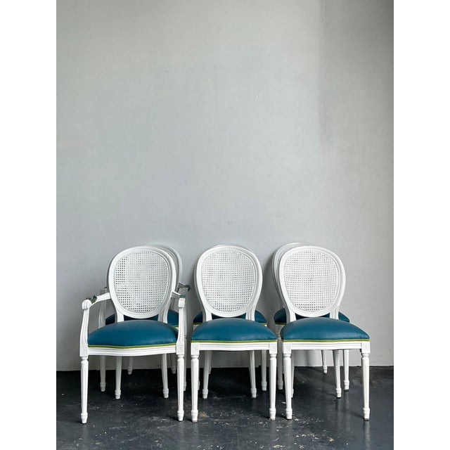 This elegant set of six vintage dining chairs showcases a refined medallion back design that blends classic European...