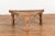 An antique rustic Indian handmade coffee table from the 19th century with trapezoidal top, iron stretchers, turned...
