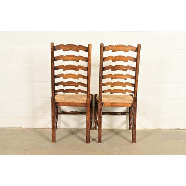 Baker Furniture Style English Country Rustic Carved Solid Oak Ladder Back Dining Chairs With Rush Seats, Pair For Sale - Image 12 of 13
