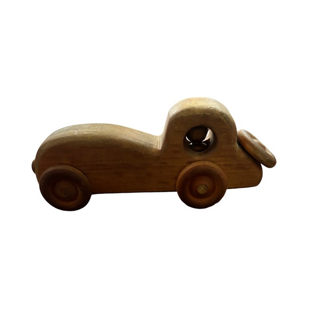 Handcrafted folk art wooden car with wheels that spin. This piece would be terrific in a study among books on a shelf, as...