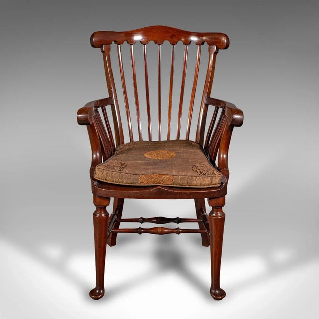This is an antique cleric's armchair. An English, mahogany and beech open elbow chair in Georgian revival taste, dating to...