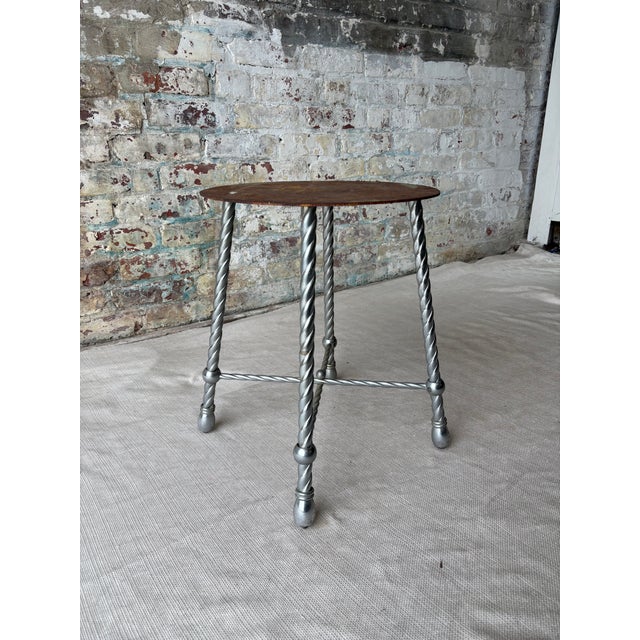 A truly extraordinary conversation piece with authentic history, this vintage metal pedestal stool was sourced in Round...