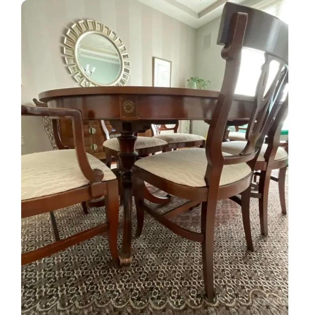 A beautifully crafted vintage mahogany dining set by Northern Furniture Company of Sheboygan, Wisconsin, a respected...