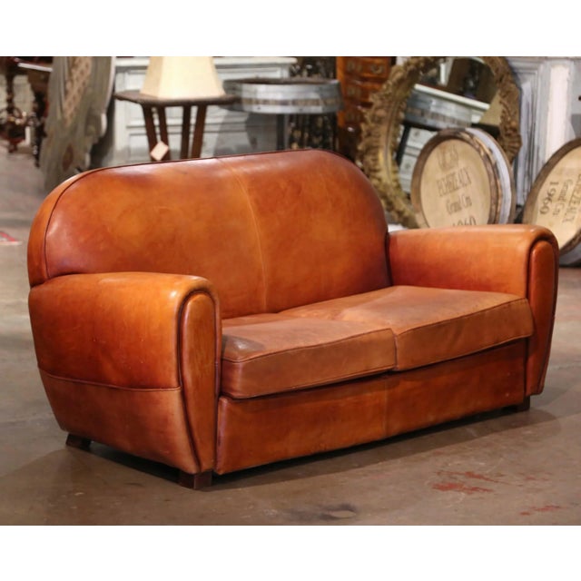This Classic, antique Art Deco club sofa was crafted in France, circa 1920. This stately couch features wide, rounded...