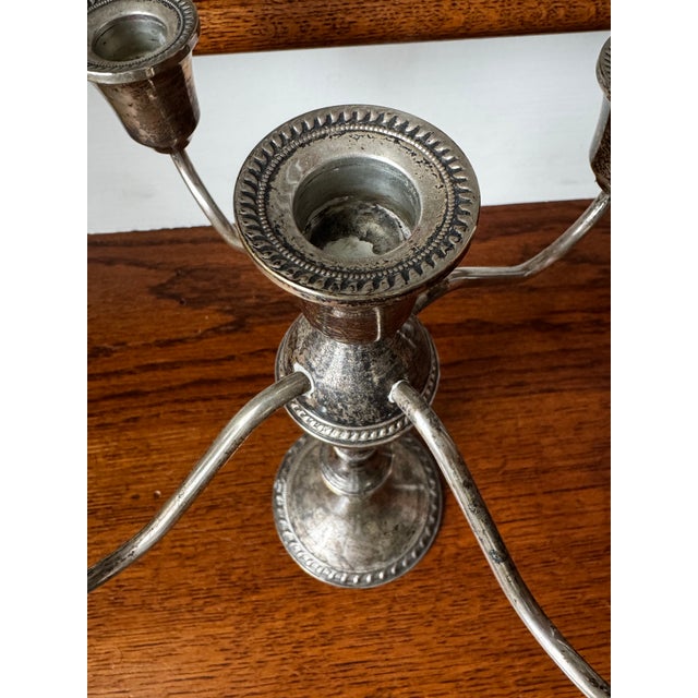 An elegant matched pair of convertible sterling silver candelabras by Duchin Creation, American, circa 1950s. Each piece...
