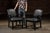 Pair of vintage revival-style upholstered armchairs. Early 20th-century Jacobean Revival armchairs featuring black vinyl...