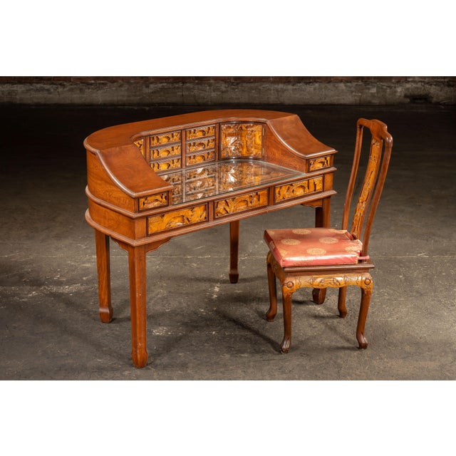 Hand-carved hardwood desk and matching chair set featuring intricate bas-relief carvings throughout. This Chinese scholars...