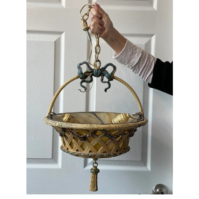 Offered for sale is a darling and so unusual floral basket chandelier. The inside lights illuminate a warm glow with the...
