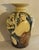 Elegant mid-century ceramic vase with a simple, sculptural form and rich glaze. Its understated design highlights the...