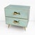 Elegant pair of nightstands featuring a refined structure clad in aqua green mirrored glass, enhanced by slender brass...