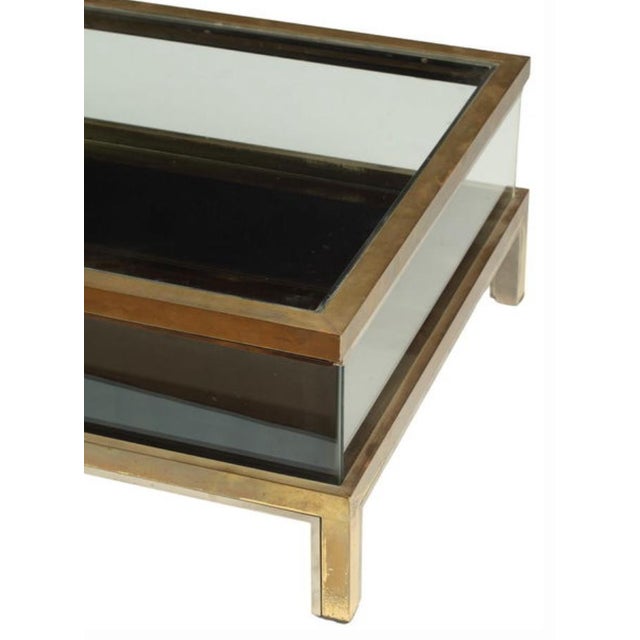 in the style of Maison Jansen, Low brass and glass vitrine coffee table, top slides open length wise, for display...
