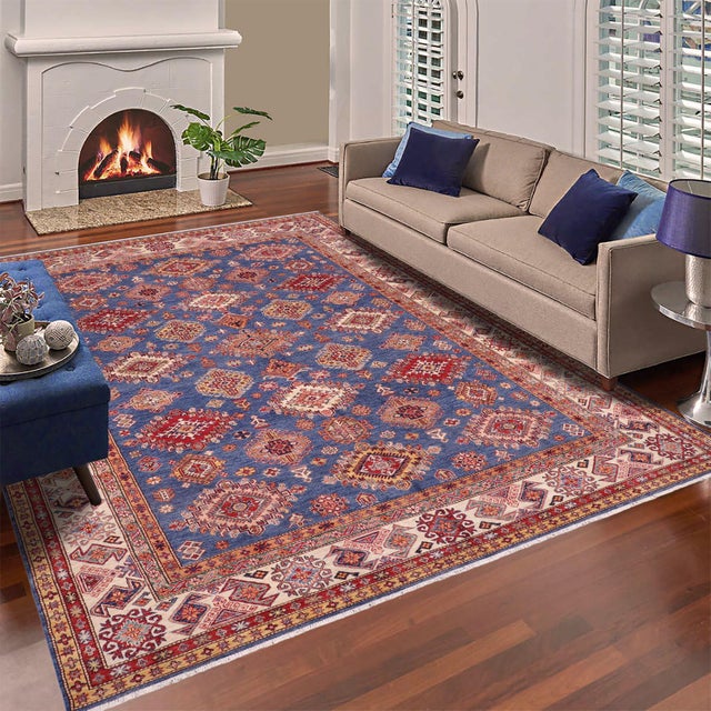 Enhance your home with this exquisite hand-knotted Super Kazak rug, crafted from fine hand-spun wool and dyed with all-...