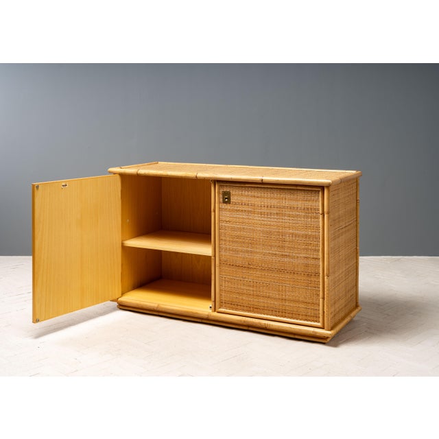 Italy, ca. 1970s. A stylish cane and bamboo cabinet by Italian designer Flam Sansoni for manufacturer Dal Vera. Featuring...