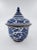 A striking blue-and-white porcelain covered Pagoda jar featuring bold hand-painted floral and scroll motifs framed with...