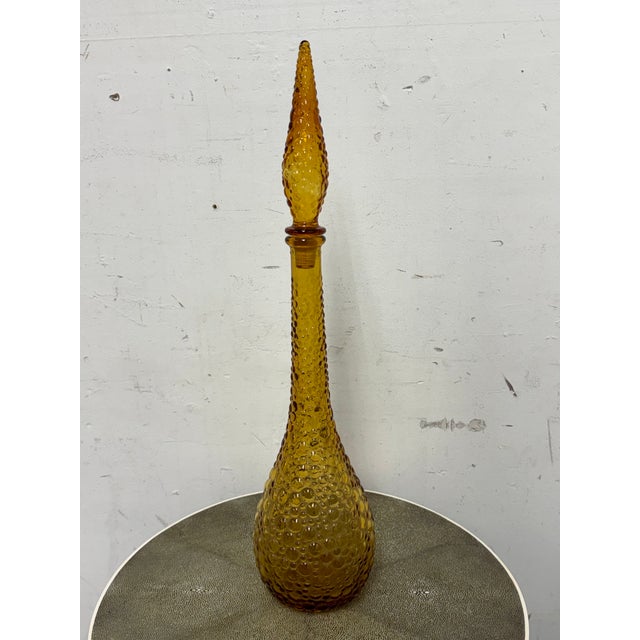 Design Plus Gallery presents an Amber Toned Hand Blown Vessel from Italy. The tall glass bottle has a textured, hobnail-...