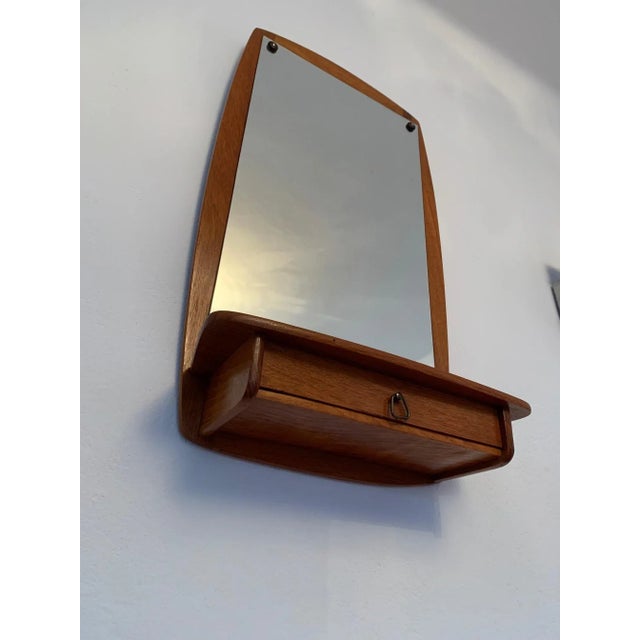 Large teak mirror with shelf and drawer from the 1960s. In original and very good condition. A classic of Danish design....