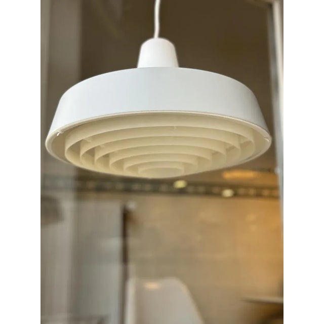 Pendant lamp with shade made of gray painted metal, inner shade made of matt glass, shade made of plastic Thanks to the...