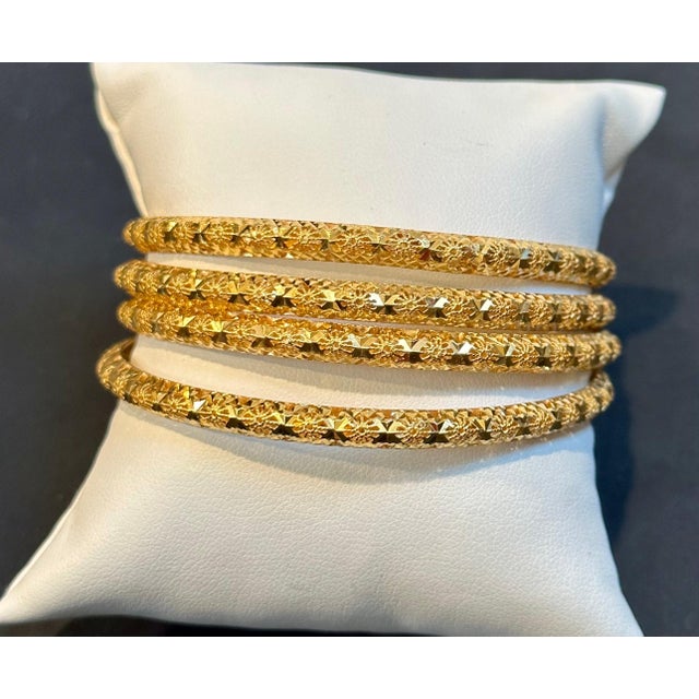 A quality set of 4 twenty two karat (21K) yellow gold bangle bracelets ,finely crafted in UAE Dubai. Slide on style...