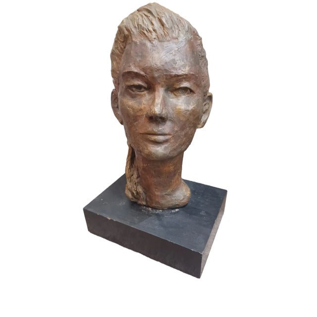 Vintage mid century lost wax sculpture of woman with ponytail. Sculpture appears to be made on clay. Comes with stand.