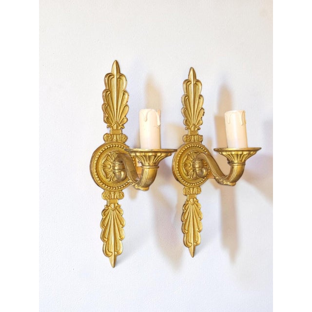Louis XVI style gilt brass wall sconces Height 30.7 cm Width 7.3 cm Depth 14.5 cm In good condition. European Plug (up to...