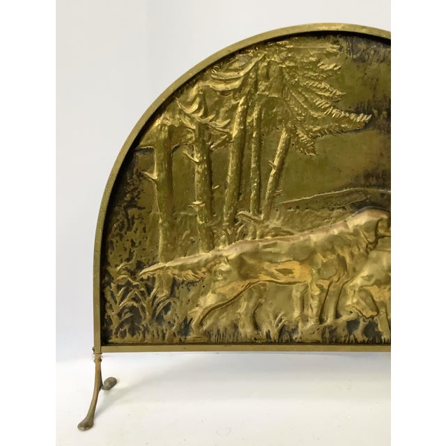 Mid-Century brass repoussé birddog fire screen beautifully done with evergreen trees in background. Original scalloped...