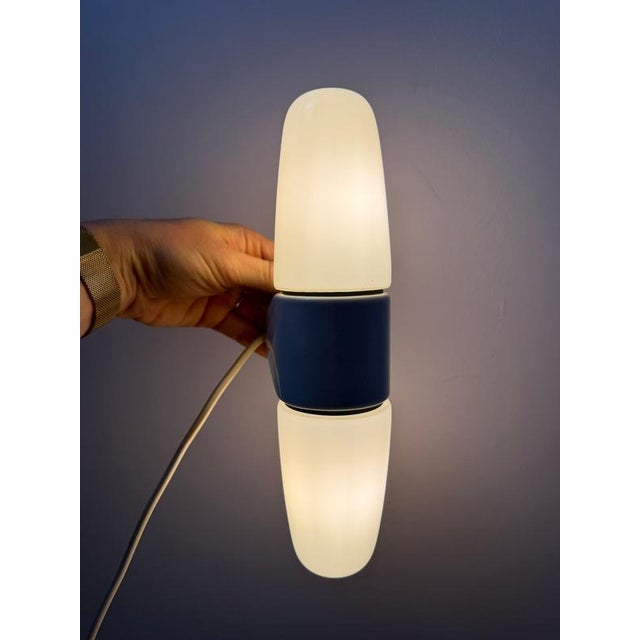 This double wall lamp, model 6068, was designed by Wilhelm Wagenfeld for the Lindner manufactory and embodies the...