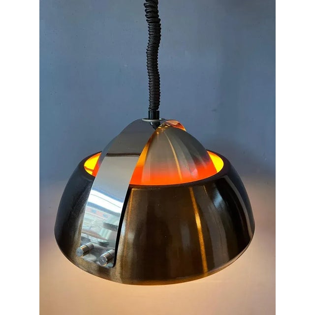 Large orange space age pendant light by Lakro Amstelveen. The lamp is made out of steel and has orange lacquer on the...