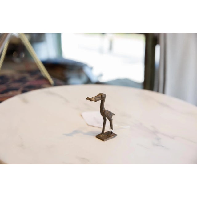 :: Vintage handmade African dark bronze stork with fish. Circa mid 20th century and possibly older, this piece has such...