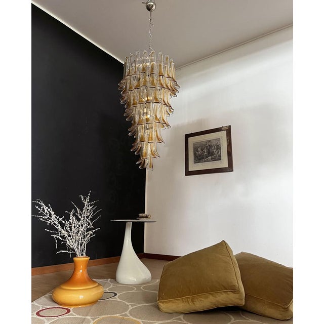 Beautiful and huge Italian Murano Chandelier composed of 83 splendid glass petals (clear with amber spot) that give a very...