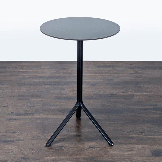 Designed by Konstantin Grcic, this table is aluminum and is for indoor or outdoor use. The top folds down. Brand: Plank....