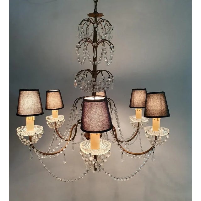 This is a Florentine Rococo style chandelier handmade in Florence, Italy circa 1950 with an array of crystals on a gilded...