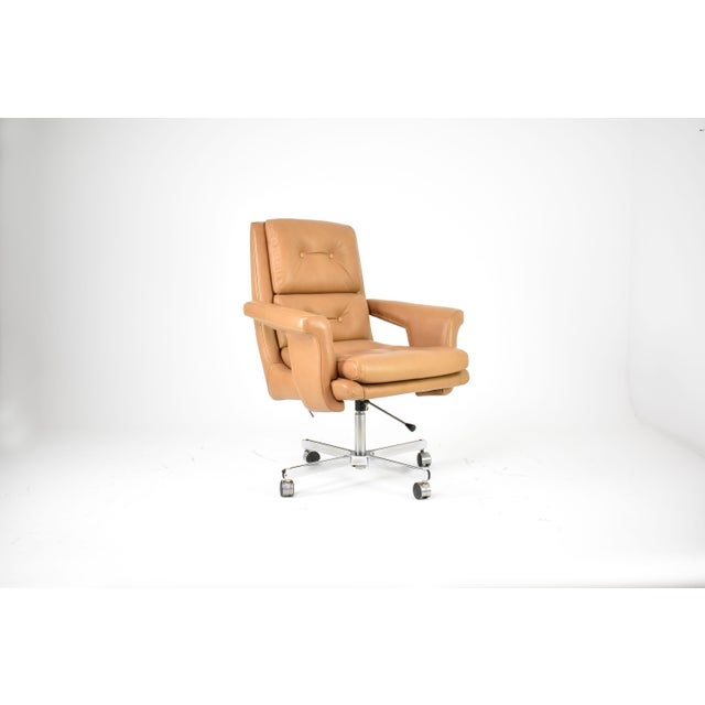 A French executive chair attributed to Raphaël Raffel for Apelbaum, dating to the 1970s. Upholstered in warm camel leather...