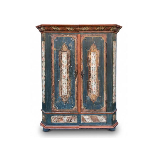 Among antique Alpine furniture, this painted wardrobe represents a testimony of Alpine production, featuring floral...