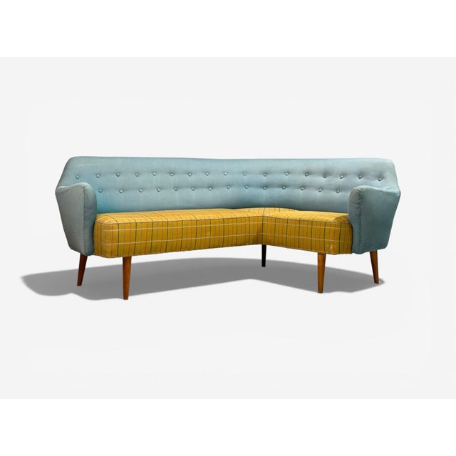 Danish Mid Century Modern, Curved Corner Sofa, Fabric, Wood, Denmark, 1950s A large modernist corner sofa designed and...