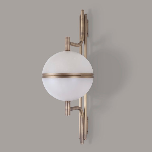 Like a coral reef, the alabaster stone has a natural flair for disguise and detail. The Andros modern wall lamp uses the...