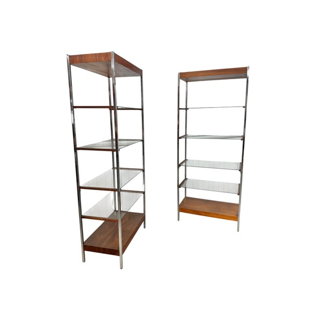 Elevate your space with this striking pair of Mid-Century Modern étagères, dating to the 1960s. Each features a sleek...