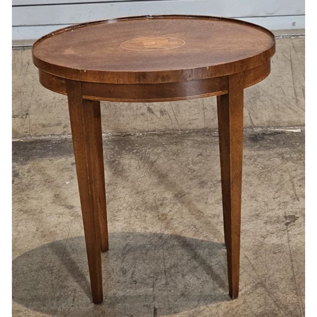 Store Item: Baker Mahogany Federal Style Shell Inlay Occasional Table Description: Table features a solid mahogany oval...