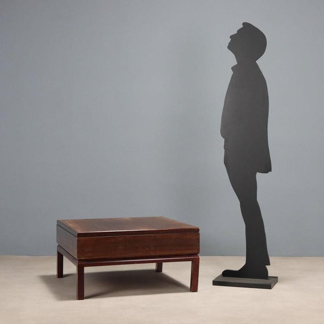 Vintage coffee table with square top made of wood with exotic wood veneer. This piece is attributed to the mentioned...