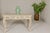 A Rococo style console table with distressed painted finish, carved apron, cabriole legs and scrolling feet. We have two...