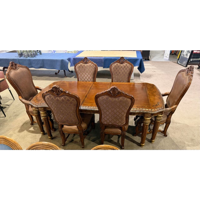 An opulent statement in classic European design, this AICO Michael Amini “Torino” dining set brings together old-world...