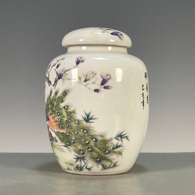 This is an elegant vintage Chinese porcelain tea jar, decorated in the famille rose palette with vibrant polychrome...